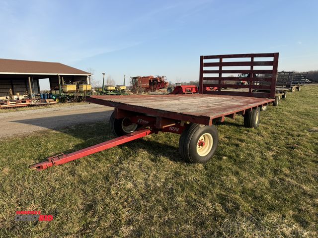 Lot 1-19116 - (1) EZ Trail Hay Wagon with rear rack, 1074 running gear, 12.5L tires, extendable tongue, 18' x 9' p...