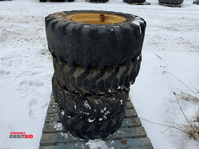 Lot 1-11692 - Lot of (4) 10-16.5 skid steer tires on 6-bolt rims, tires are foam filled, 1 tire shows extreme wear...