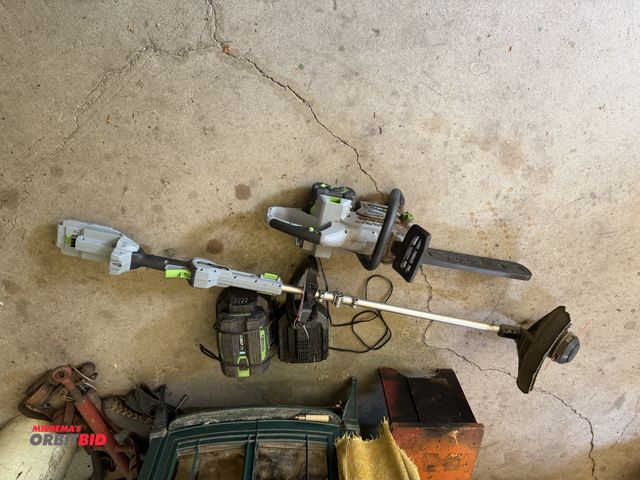 Lot 1-3279 - (1) EGO electric chain saw and weep whip, comes with (2) batteries and (2) chargers