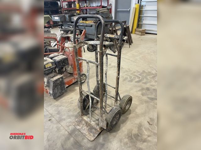 Lot 1-18823 - Lot of (2) metal hand trucks dollies, 1 with solid wheels, 1 with tires that will need to be replace...
