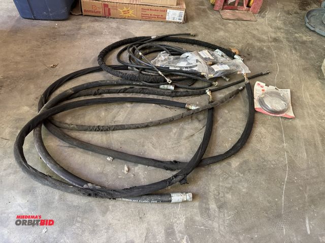 Lot 1-14234 - Large lot of assorted heavy duty hydraulic hoses, and new 48" braided reinforced hose with threaded ...