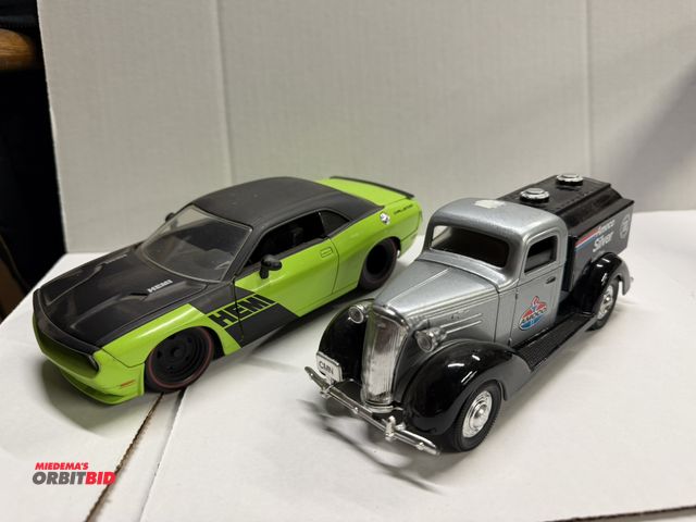 Lot 1-8283 - (1) Diecast Challenger Hemi model, and (1) diecast vintage Amoco Silver fuel truck bank with key.