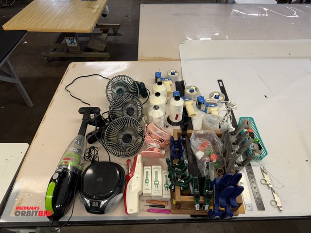 Lot 1-4912 - Lot of assorted items, includes (4) assorted desk fans with clamps, tape guns, (1) Bissell Pet Hair ...