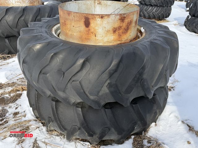 Lot 1-11621 - (1) set of used 18.4-34 clamp on duals, tires are dry rotted, cut, and weather checked.