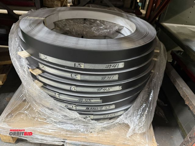 Lot 1-18673 - Lot of (9) coils of 1.5" x .016" PPB, pre painted black anodized aluminum coils.