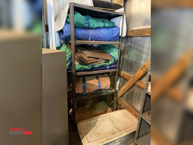 Lot 1-12341 - (1) 30" adjustable metal shelf, with assorted tarps, and plastic container full of tarps.