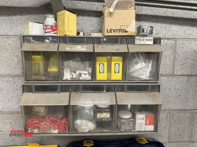 Lot 1-17116 - (1) 24" wide wall mounted plastic parts cabinet, includes staples, wire nuts, Hubbell plugs, fluores...