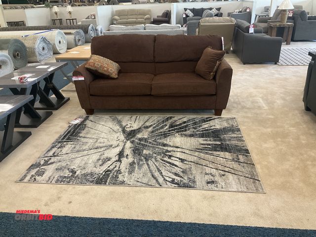 Lot 1-17176 - Brown couch with (2) pillows and a rug. Couch measures 79” x 39”. Rug measures 86” by 58”