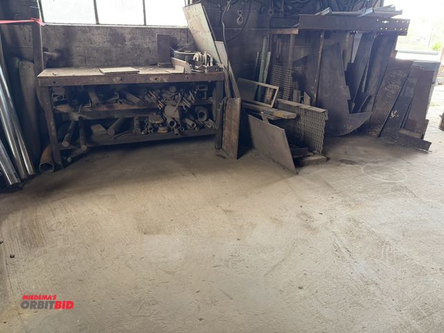Lot 1-18103 - (1) 65" length x 33" height x 30" depth wood work bench with assorted scrap steel, steel cuts, plate...