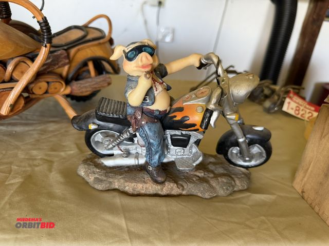 Lot 1-8225 - (1) porcelain, approx. 9" long x 6" tall hog on a motorcycle collectible.
