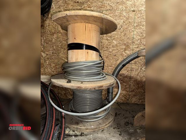 Lot 1-4296 - (2) partial spools of 4/0 AWG copper wire, gray, each measures 23.5" diameter x 20" tall.