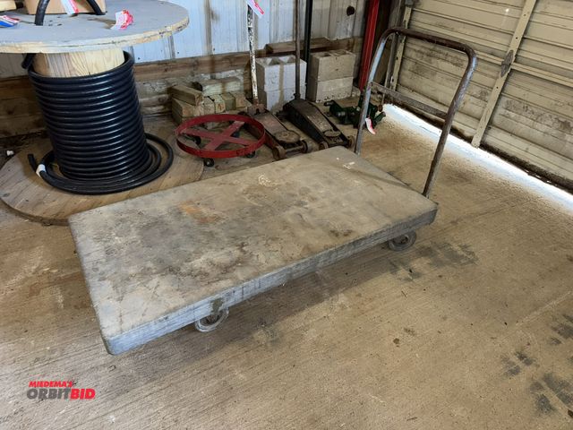 Lot 1-4562 - (1) product cart, 59" length x 29.5" width x approx. 11" height, platform is plastic.