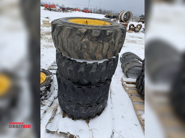 Lot 1-11688 - Lot of (4) skid steer tires on 8-bolt rims, size 12-16.5, rims appear to be heavy duty.