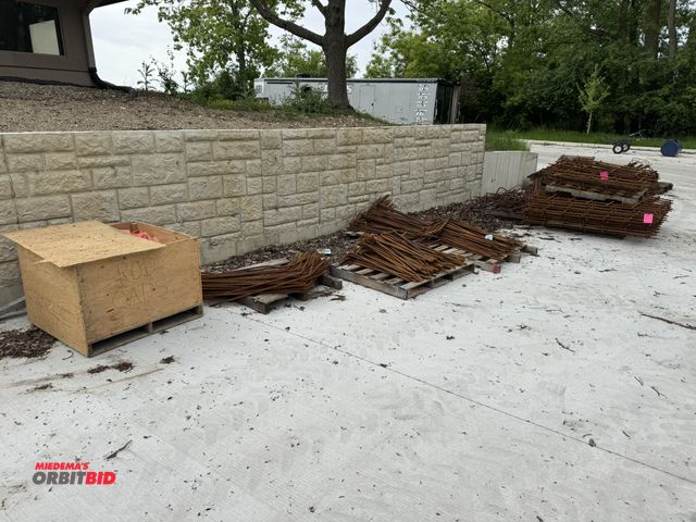 Lot 1-18710 - Large lot of assorted concrete rerod pieces, (1) wooden box of rod caps (14 skids total), winning bi...