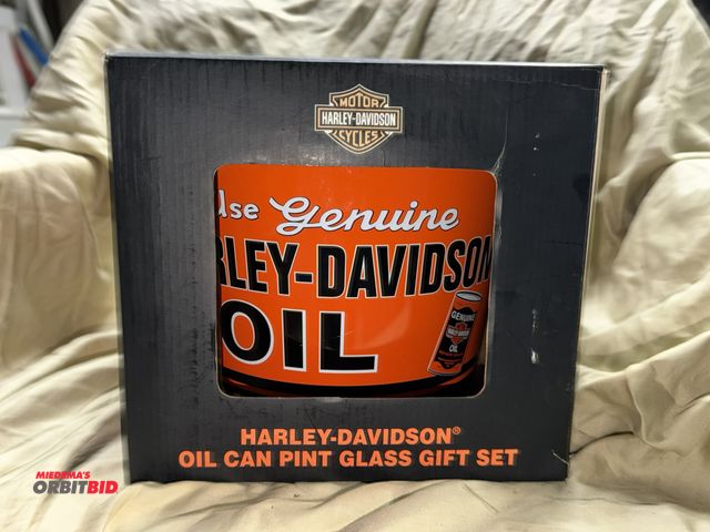 Lot 1-8288 - (1) Harley Davidson oil can pint glass gift set with metal bucket (bucket rim is slightly misshapen)...