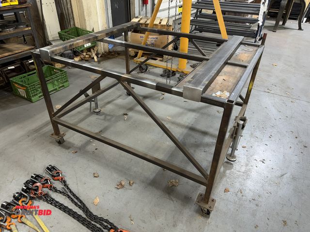 Lot 1-18764 - (1) metal framed table on casters with front and rear stops, 48" wide x 60" long x approx. 37.5" tal...