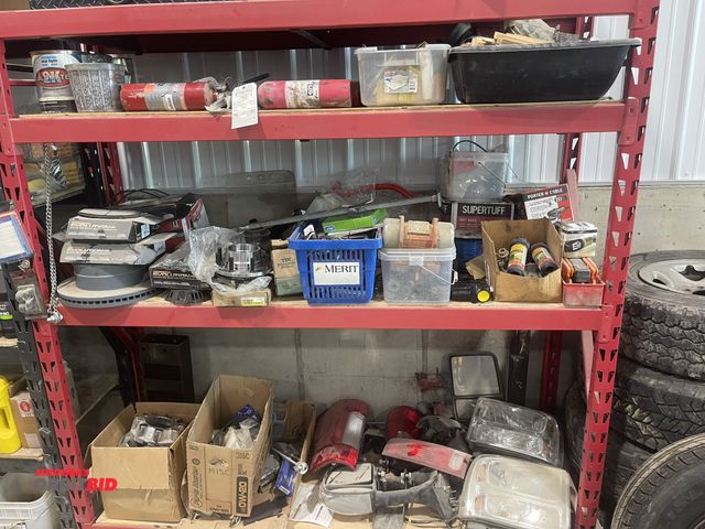 Lot 1-18762 - (1) rack with contents, includes assortment of Ford headlights, mirrors, tail lights, lug nut covers...
