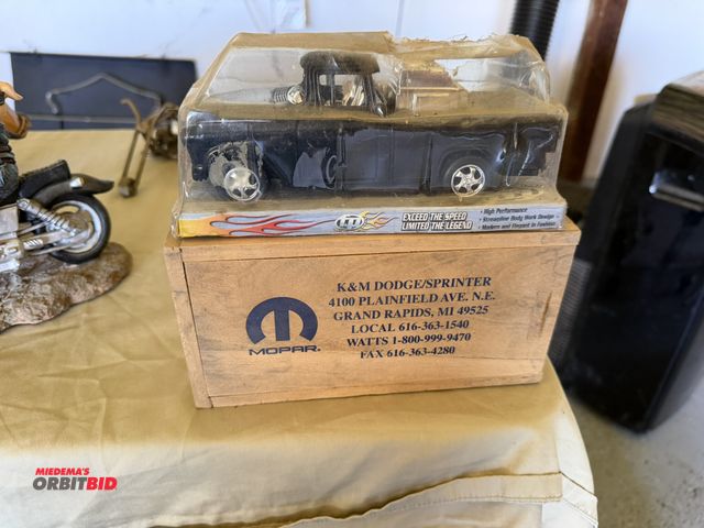 Lot 1-8223 - (1) Friction Powered Series collectible model car, and (1) Mopar 8" x 4" x 3" wood box with sliding ...