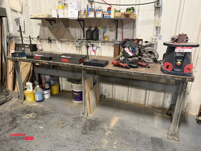 Lot 1-18562 - (1) steel shop table, 9' long x 29" deep x 34" tall, includes upper shelf with 6" gold disc rolls, 8...