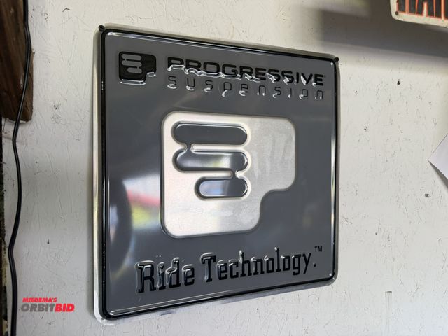 Lot 1-8182 - (1) 17" x 17" "Progressive Suspension" tin sign.