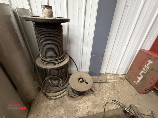 Lot 1-1492 - (2) partial rolls of 1/4" reinforced rubber tube, and (1) partial spool of 4 gauge copper wire.