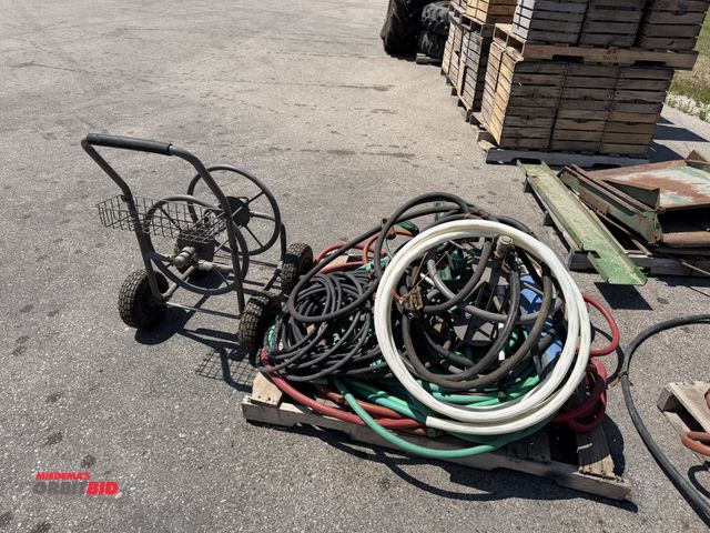 Lot 1-18404 - Skid lot of assorted garden hose, includes hose reels, and more.