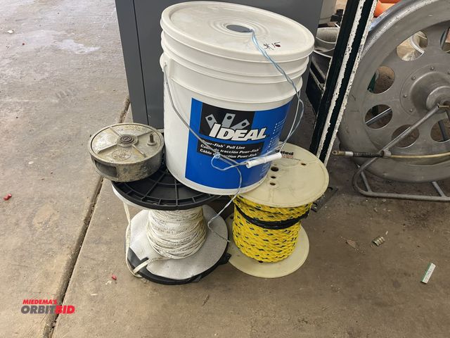 Lot 1-6221 - (3) partial pulling ropes, (1) bucket of Ideal Power Fish pull line, (1) 1/4" flat pull line, and (1...