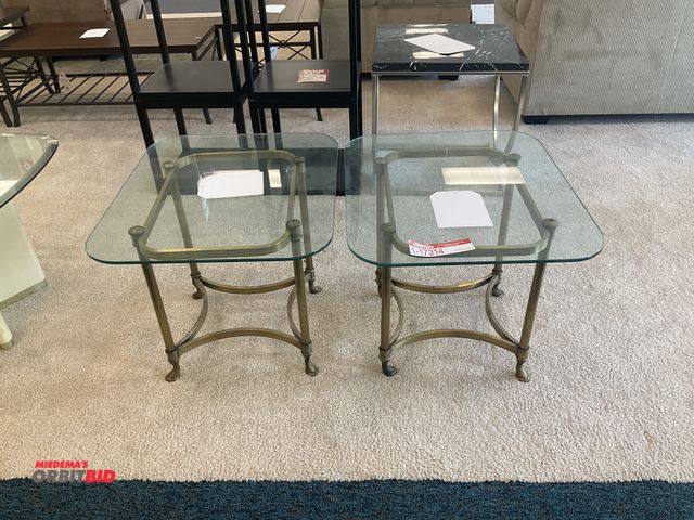 Lot 1-17214 - (2) glass top end tables. Measure 28” by 24” by 22” tall