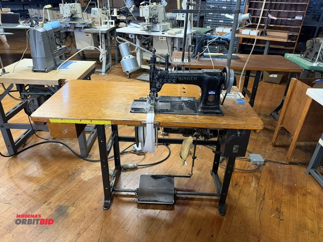 Lot 1-4663 - (1) Singer, model 131WSV17, commercial sewing machine with a Singer power table, 1/2 HP, 3 phase mot...