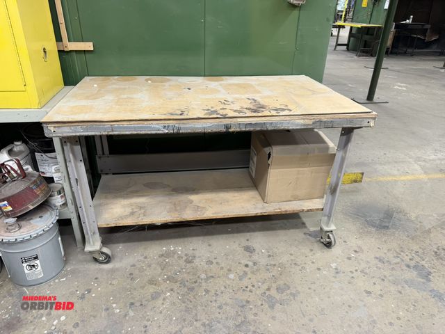 Lot 1-17661 - (1) rolling steel table with wood top, 60" x 34" x 35" tall.