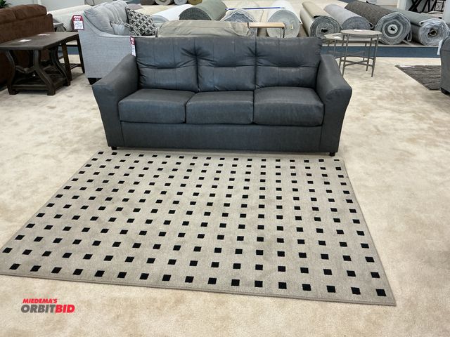 Lot 1-17189 - Lot includes grey upholstery sofa measuring approximately 80”Wx34”Hx32”D and area rug measuring appr...