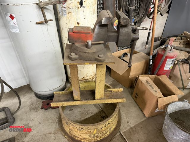 Lot 1-1566 - (1) heavy duty 6" bench vise mounted to a custom built, heavy duty steel 26.5" tall stand.