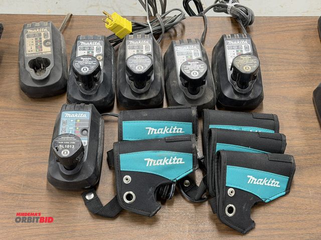 Lot 1-16856 - Lot of (6) Makita 7.2 through 10.8/12V chargers, includes (5) batteries, and (4) Makita drill holder...