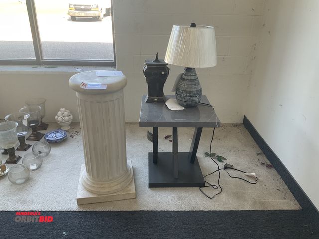 Lot 1-17208 - End table with lamp, decorative vase and a decorative column. Table measures 22” by 22” by 24” tall....