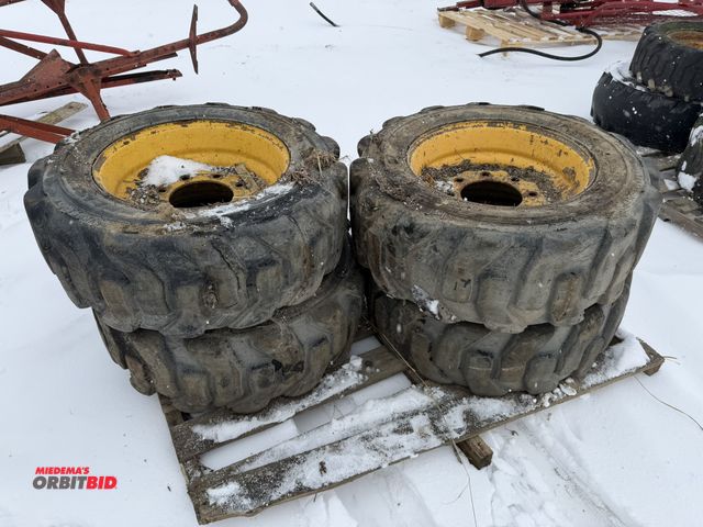 Lot 1-11693 - Lot of (4) used 10-16.5 skid steer tires on 8-bolt rims.