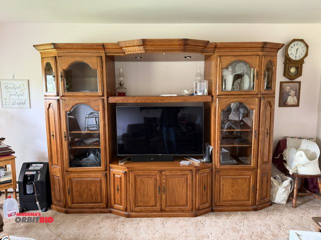 Lot 1-12160 - (1) 3-piece, lighted oak entertainment center/cabinet, approx. 9' long x 35" deep, includes slide ou...