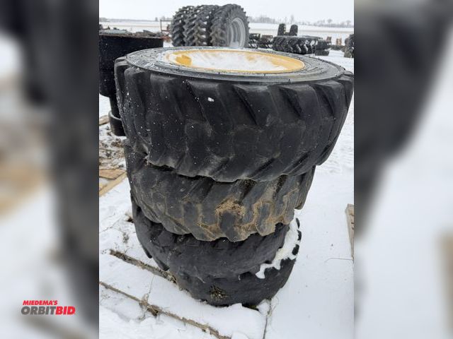 Lot 1-11695 - Lot of (4) used 10-16.5 skid steer tires on 8-bolt rims.