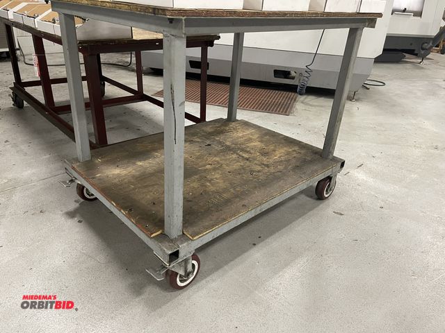Lot 1-19383 - (1) 4' x 36" heavy duty steel frame cart with wood top and locking caster wheels.