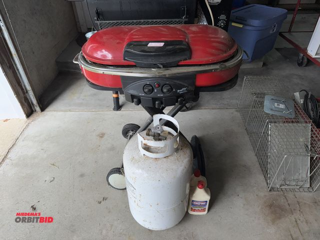 Lot 1-610 - (1) Coleman Road Trip portable propane grill, includes 30 lb. propane tank.
