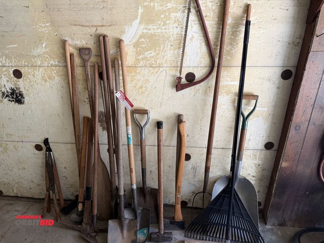 Lot 1-3271 - Assorted shovels, rake, broom, pitch fork, post hole digger, axe, and more