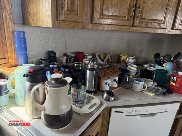 Lot 1-19165 - Large lot of assorted coffee mugs, thermos, cutting boards, utensils, coffee, cup warmer, assorted k...