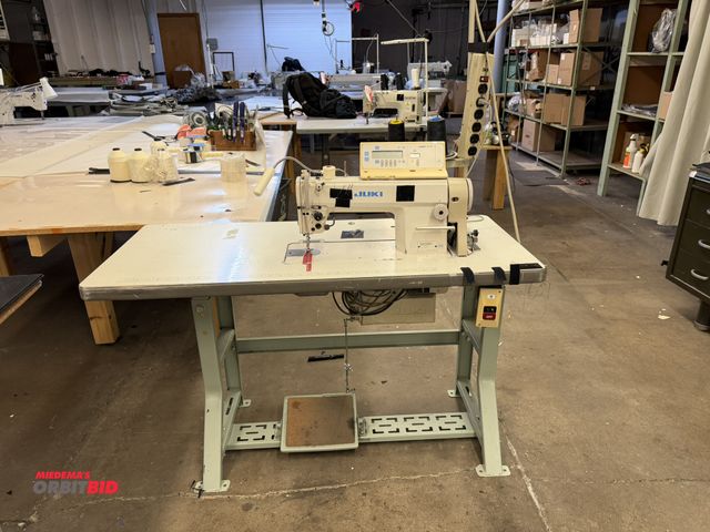 Lot 1-4722 - (1) Juki sewing machine, model DLN-5410N-7, with power table and spool rack, table is 47" wide x 21"...