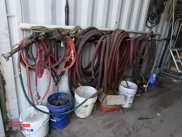 Lot 1-2995 - Large lot of assorted heavy duty air hoses, includes hydraulic hoses, buckets of assorted metal part...