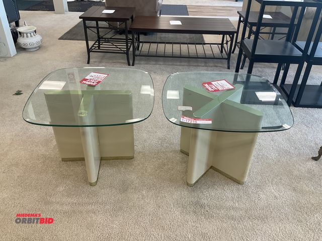 Lot 1-17215 - (2) Glass top end tables. Measure 28” by 28” by 21” tall