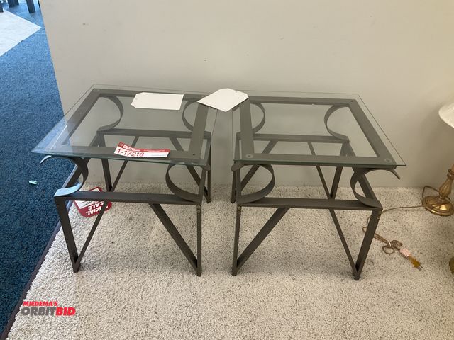 Lot 1-17216 - (2) Glass top end tables measuring 20” by 20” by 21” tall
