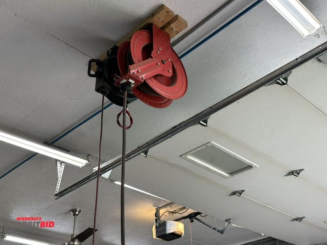 Lot 1-590 - (1) Tekton retractable air hose reel, approx. 50', and (1) Husky 50' retractable extension cord reel...