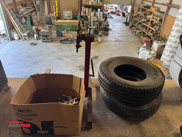 Lot 1-14242 - (1) engine stand, (1) Transforce Firestone tire, LT26575R16, and (1) steel radial, LT23585R16 tire a...