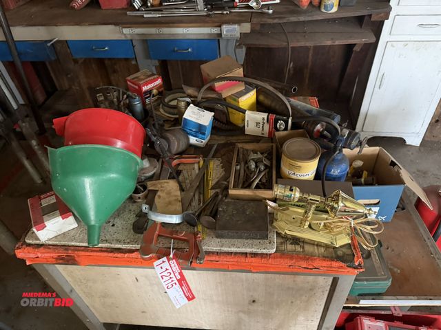Lot 1-12115 - Large lot of assorted automotive items, includes funnels, grease guns, muffler clamps, muffler pipe ...