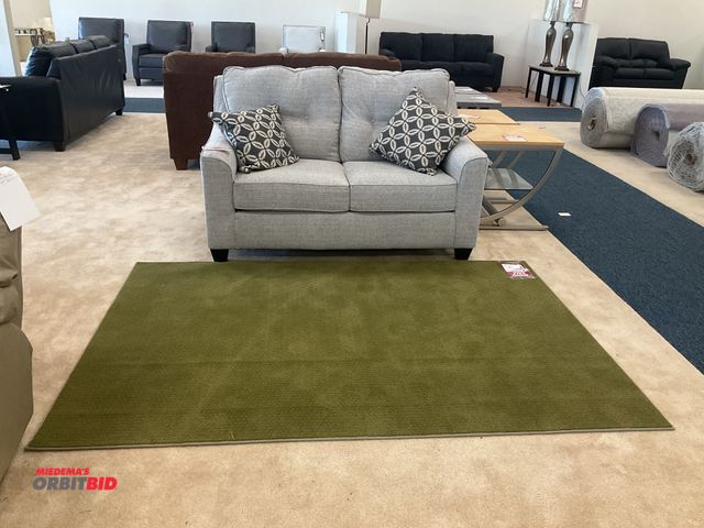 Lot 1-17173 - Grey loveseat with (2) pillows and a rug. Loveseat measures 60” by 36” deep. Rug measures 90” by 60”