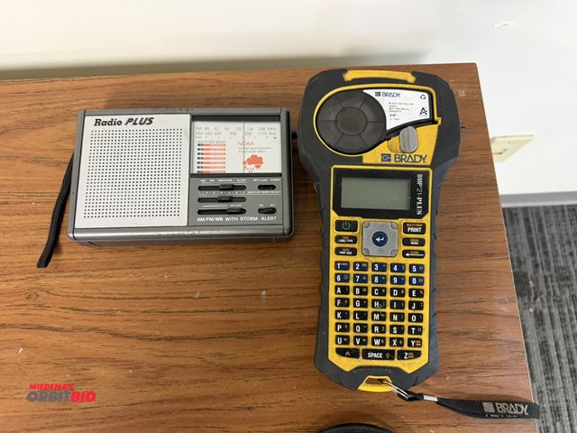 Lot 1-15662 - (1) Brady, model BMP21-PLUS, black on yellow vinyl, 3/4" tape label maker, in working condition, and...